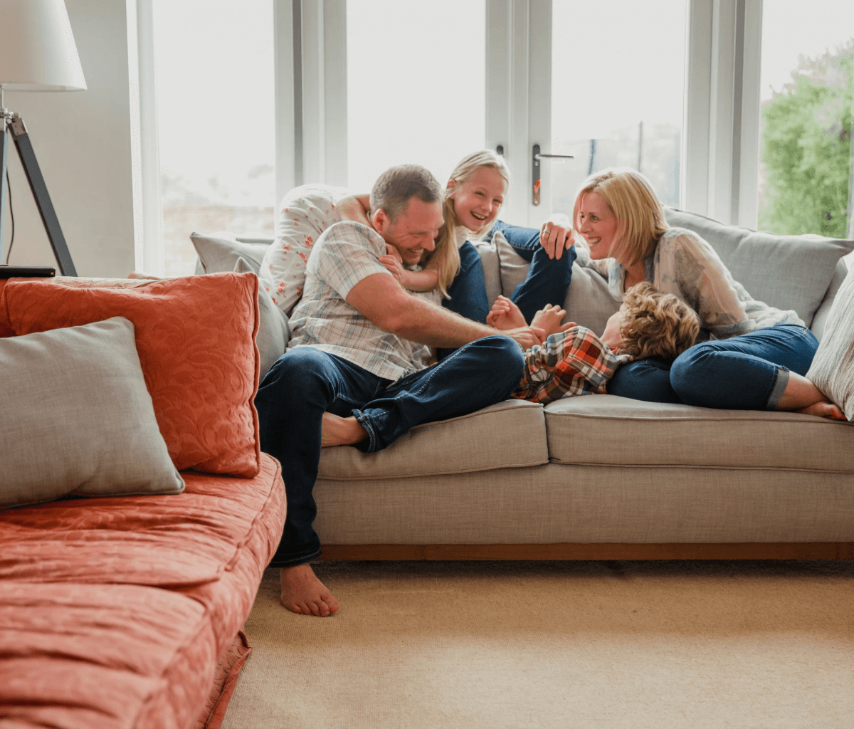 Ecology Mortgage Members having family time on the sofa in their new energy efficient home